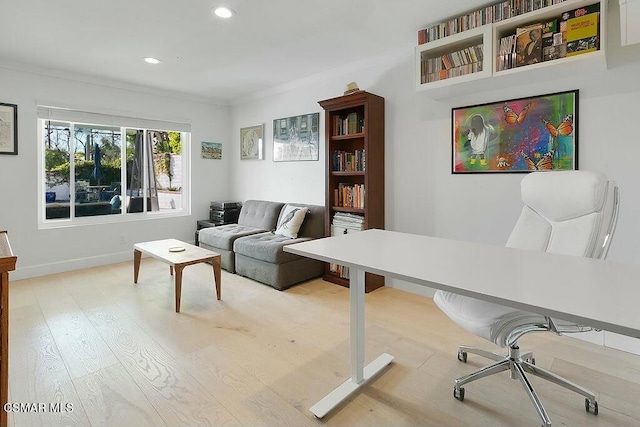 office featuring light wood-type flooring and ornamental molding