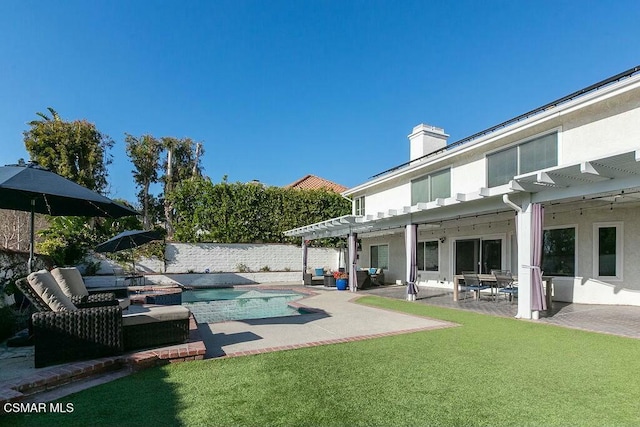 back of property with a patio area, a fenced in pool, a lawn, and a pergola