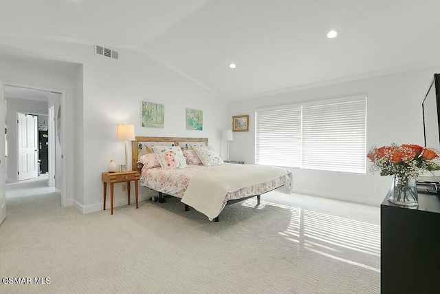 bedroom featuring lofted ceiling, ornamental molding, and light carpet