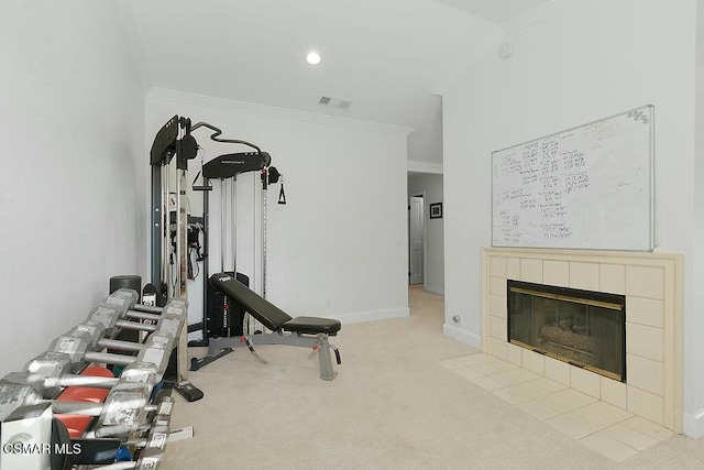 workout room with light colored carpet, ornamental molding, and a fireplace