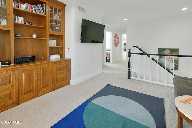 living room featuring light colored carpet and ornamental molding