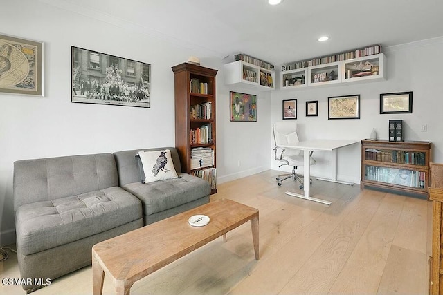 office featuring ornamental molding and light hardwood / wood-style floors