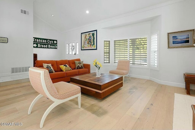 living room with ornamental molding, lofted ceiling, and hardwood / wood-style flooring