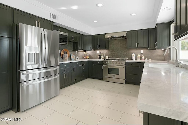 kitchen with range hood, decorative backsplash, sink, light stone countertops, and stainless steel appliances