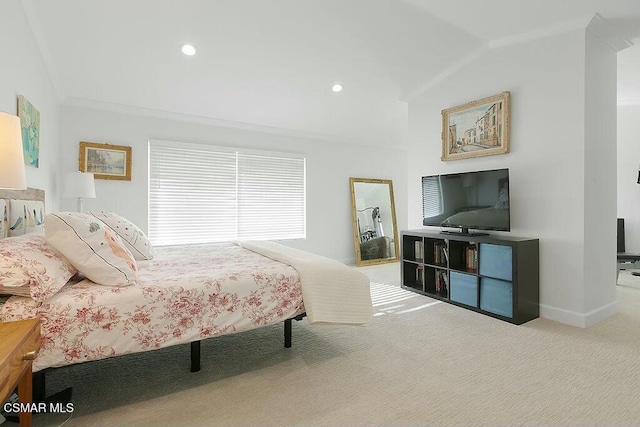 carpeted bedroom with lofted ceiling and ornamental molding