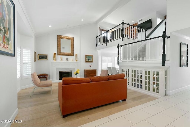 living room with high vaulted ceiling, ornamental molding, and hardwood / wood-style flooring