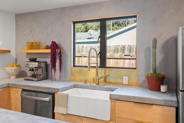 kitchen with sink, light brown cabinets, and stainless steel dishwasher