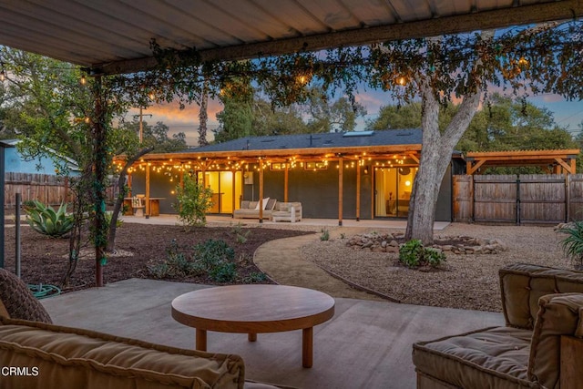 view of patio terrace at dusk