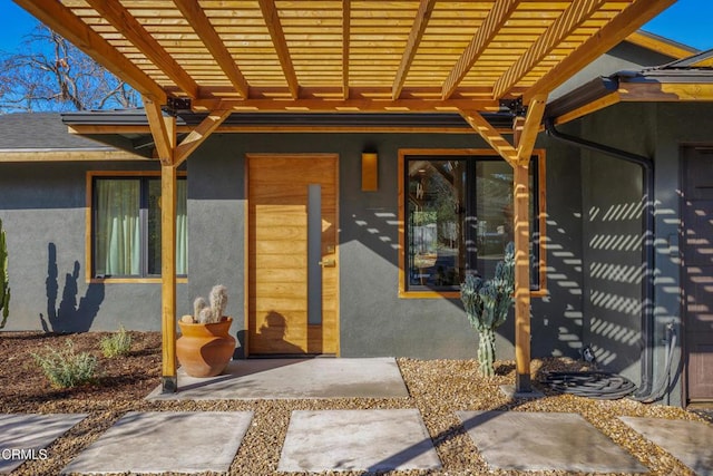 doorway to property featuring a pergola and a patio area