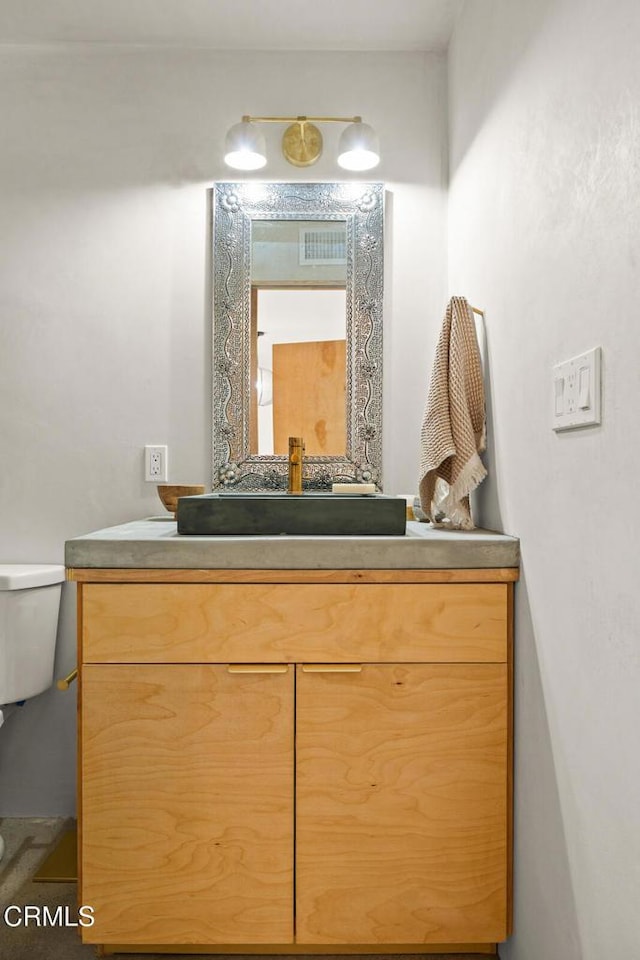 bathroom with toilet and vanity