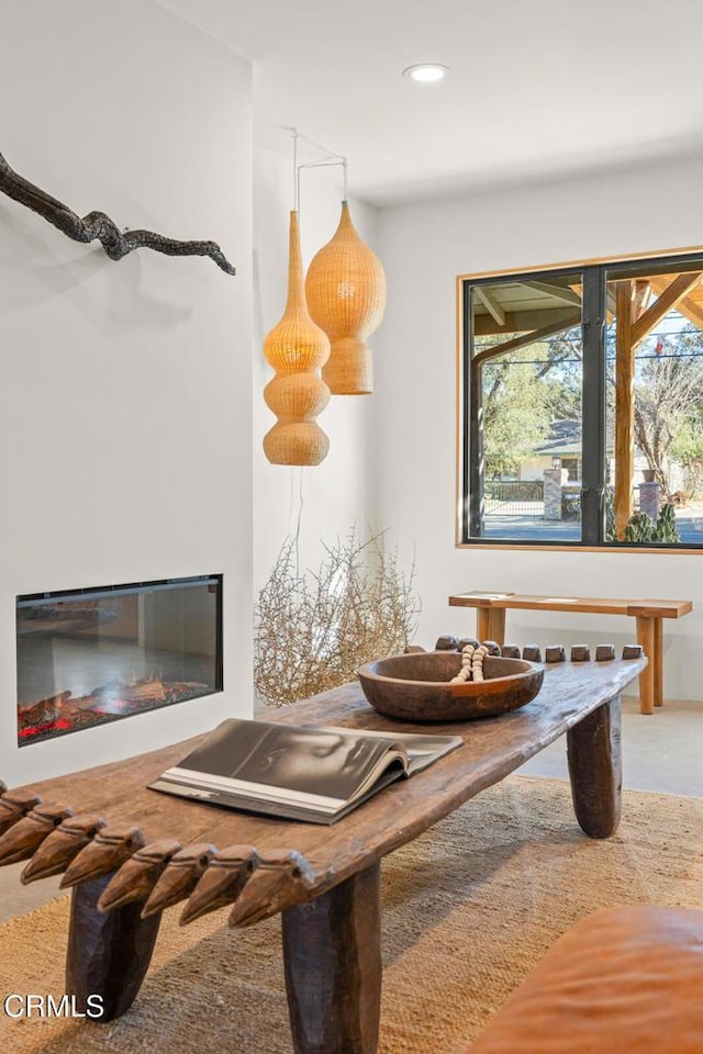 interior space with recessed lighting and a glass covered fireplace