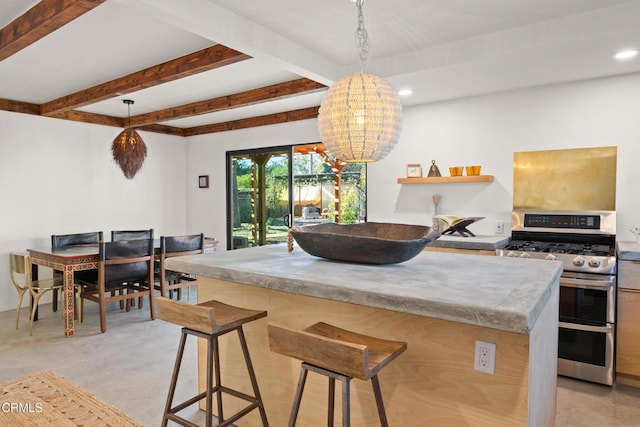 kitchen featuring range with two ovens, a kitchen island, a kitchen breakfast bar, beam ceiling, and recessed lighting