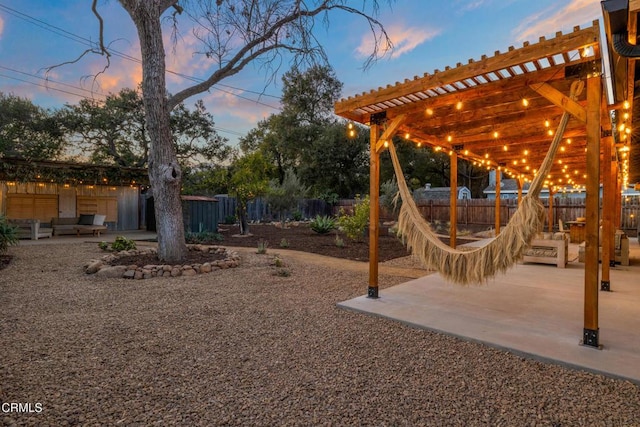 view of yard featuring a patio area, a pergola, and fence