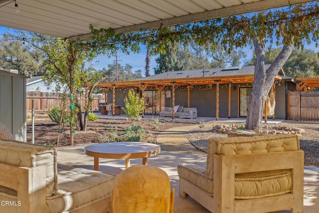 view of patio / terrace featuring an outdoor living space and fence