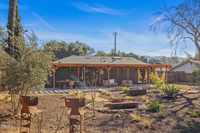back of house featuring a patio area, a pergola, an outdoor fire pit, and fence