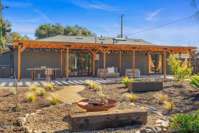 rear view of house featuring central air condition unit, a pergola, roof with shingles, outdoor lounge area, and a patio area