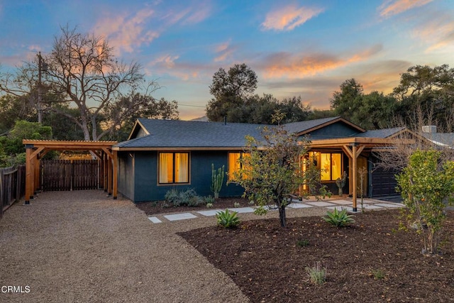 ranch-style house featuring a carport, a shingled roof, and fence