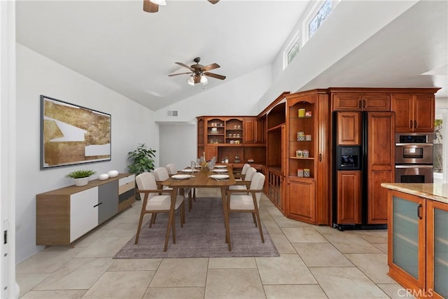 tiled dining area featuring high vaulted ceiling and ceiling fan