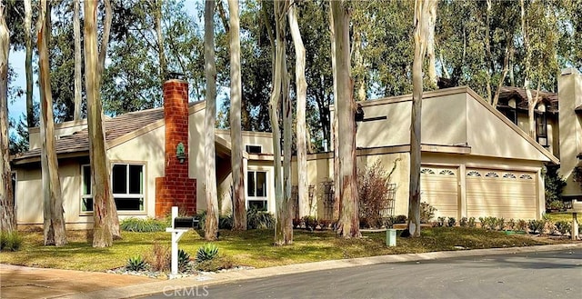 view of front facade with a garage and a front lawn