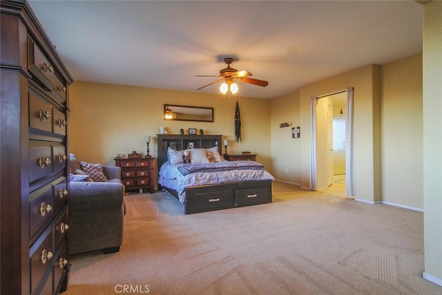 bedroom featuring light colored carpet and ceiling fan