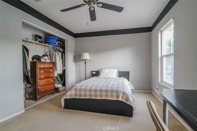 bedroom featuring light carpet, a closet, and ceiling fan