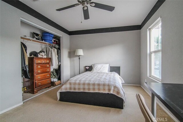 bedroom with light colored carpet, a closet, and ceiling fan