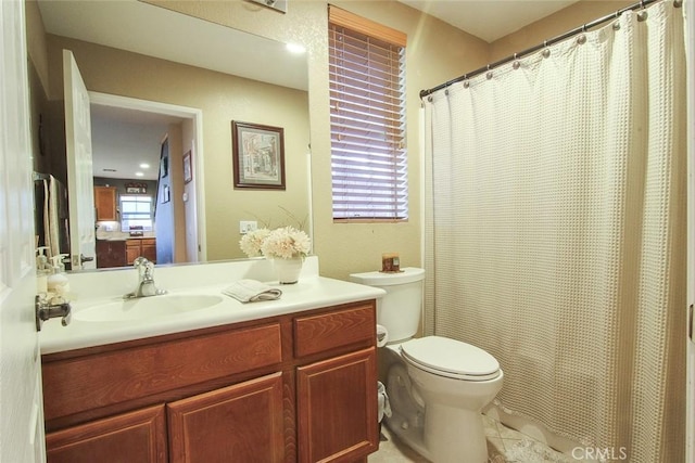 bathroom with toilet, tile patterned flooring, and vanity