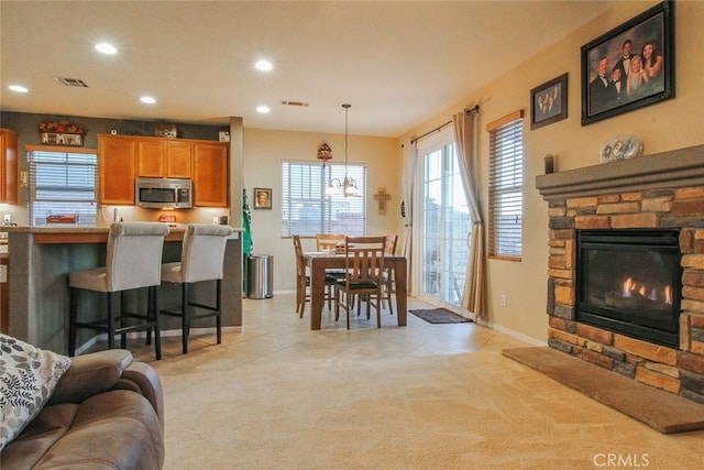 living room with light colored carpet and a fireplace