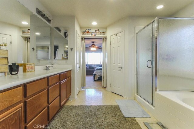 bathroom with ceiling fan, vanity, and plus walk in shower