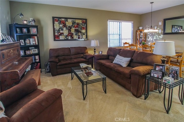 living room featuring an inviting chandelier and light colored carpet