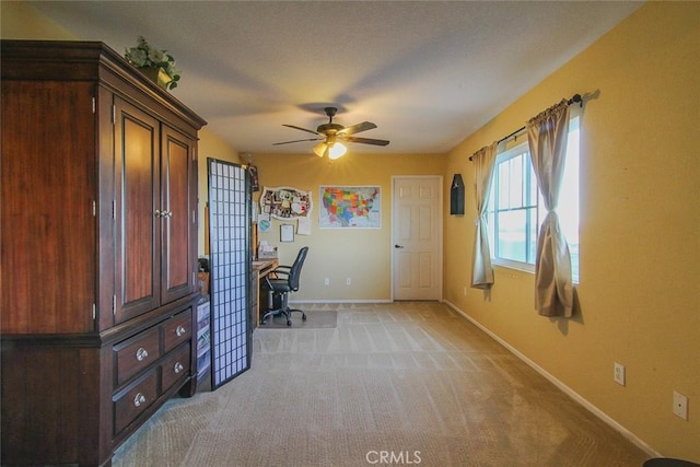 unfurnished office with light carpet and ceiling fan