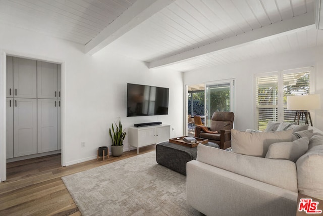 living room featuring hardwood / wood-style flooring and beam ceiling