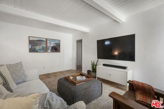 living room featuring beam ceiling and wood-type flooring