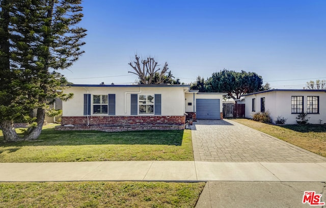 ranch-style home with a front yard and a garage