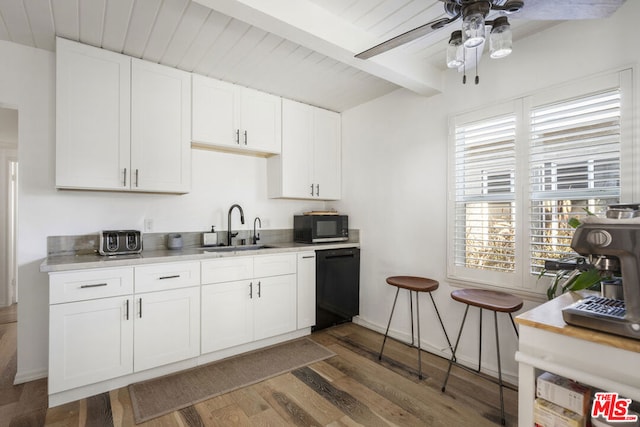 kitchen featuring white cabinets, black appliances, dark wood-type flooring, beamed ceiling, and sink