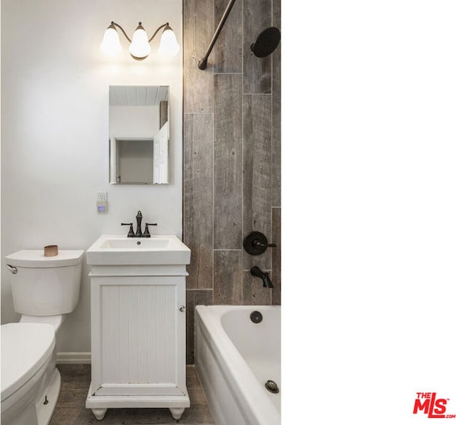 full bathroom featuring toilet, vanity, and tiled shower / bath combo