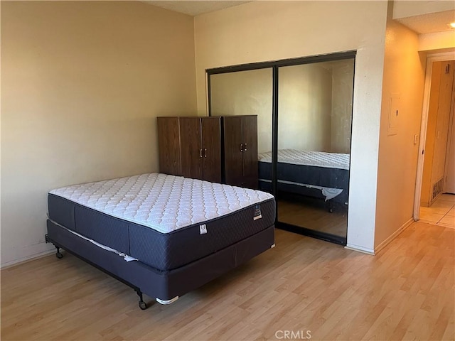 bedroom featuring a closet and light wood-type flooring