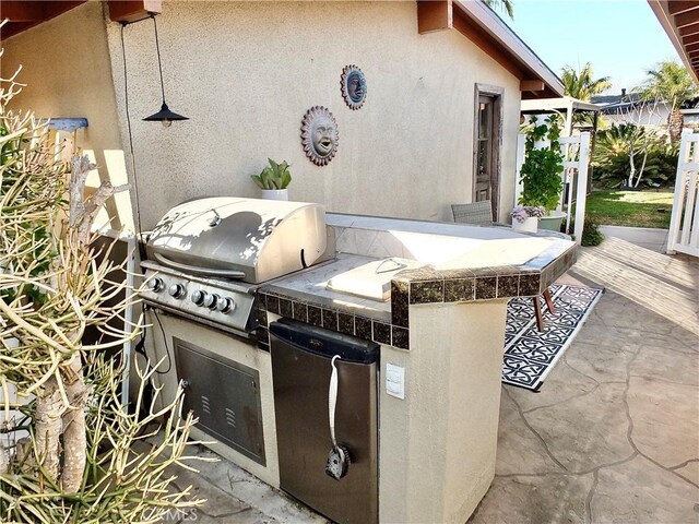 view of patio / terrace featuring area for grilling and a grill