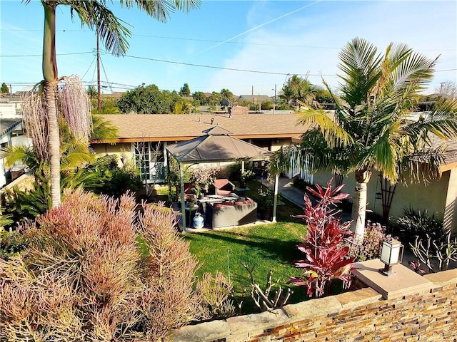 view of front of property featuring a gazebo and a front yard