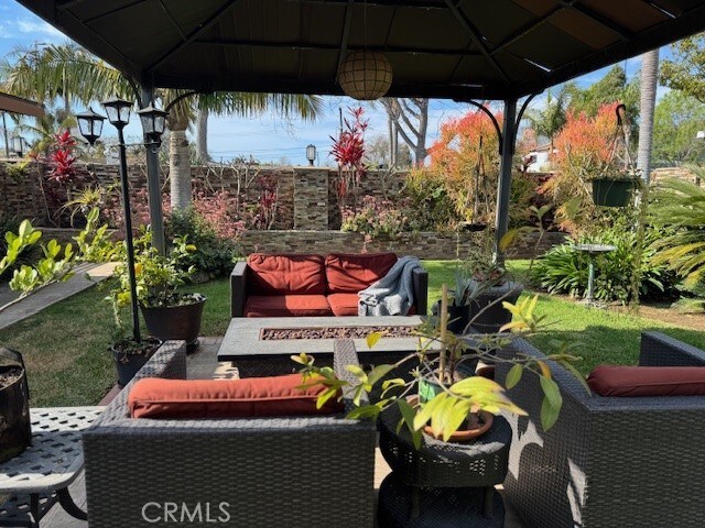 view of patio featuring a gazebo and an outdoor living space with a fire pit