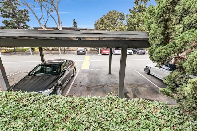 view of parking / parking lot featuring a carport