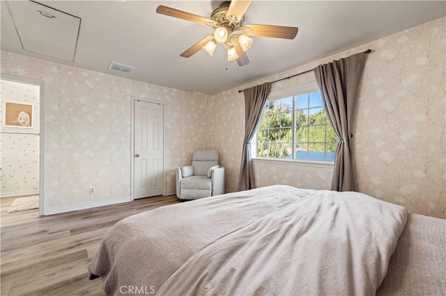 bedroom with ceiling fan and light hardwood / wood-style floors