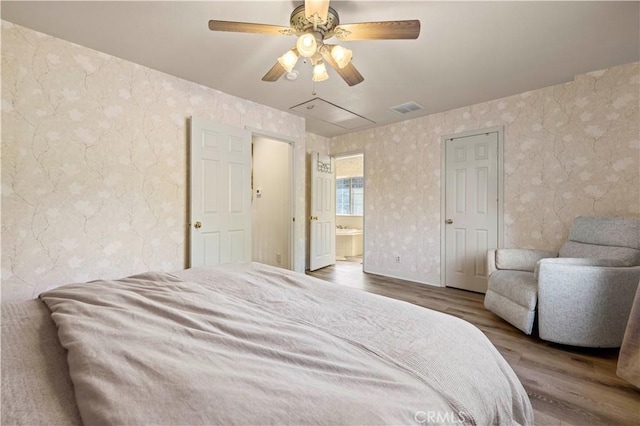 bedroom featuring ceiling fan, wood-type flooring, and connected bathroom