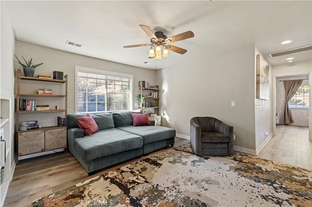 living room with ceiling fan and hardwood / wood-style floors