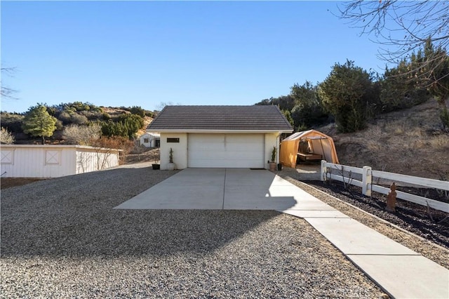 exterior space featuring a garage and an outdoor structure