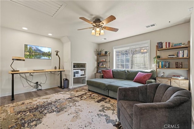 living room featuring ceiling fan and light hardwood / wood-style flooring