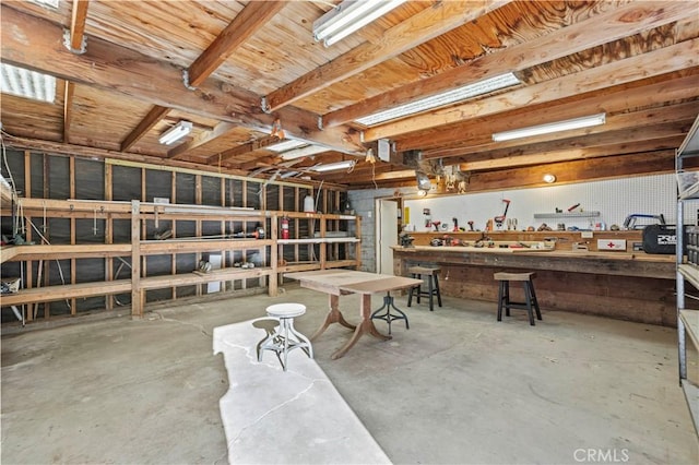 miscellaneous room featuring concrete flooring and a workshop area