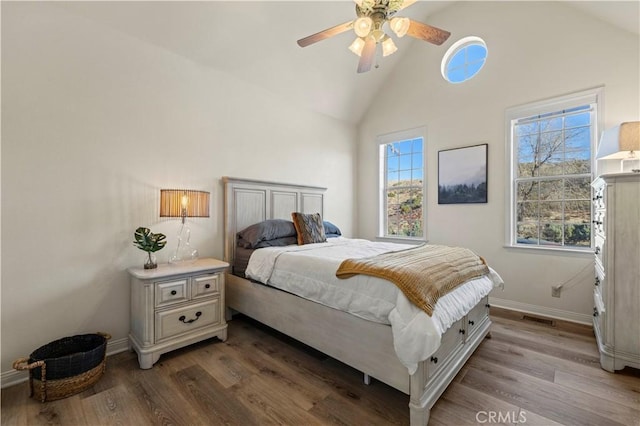 bedroom featuring ceiling fan, wood-type flooring, and high vaulted ceiling