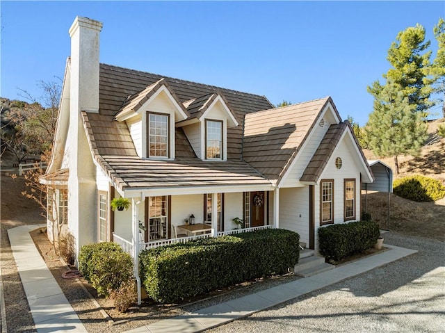 cape cod-style house with a porch