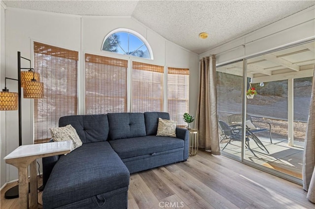 sunroom / solarium featuring vaulted ceiling